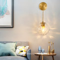 Copper wall lamp with suspended grain glass ball